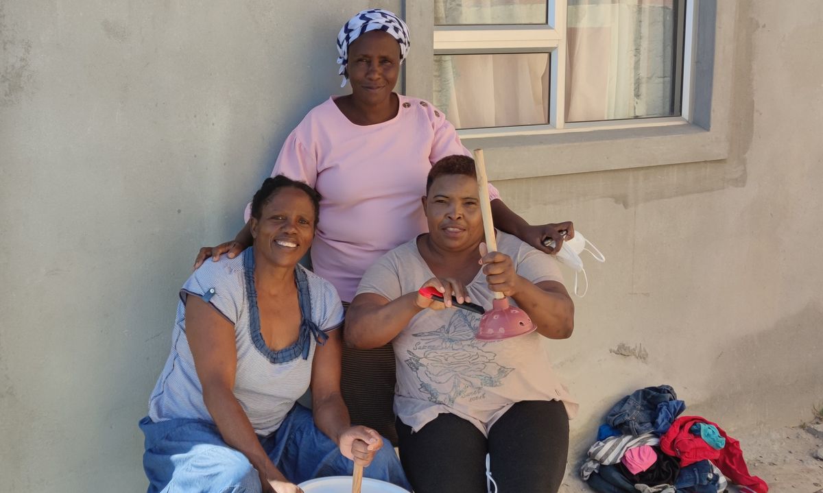 Women using a bucket washing machine