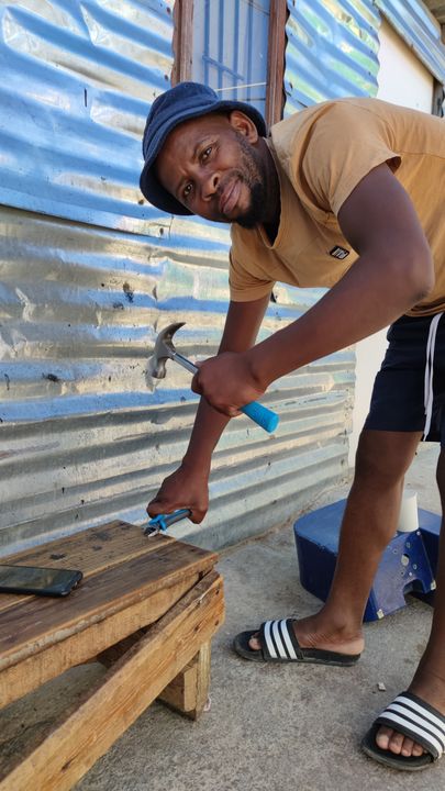 Man fixing up a bench