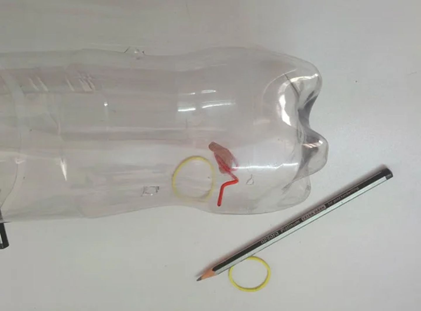 Insert paper clip into bottle