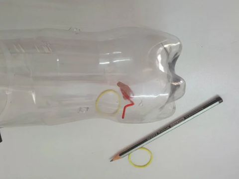 Insert paper clip into bottle