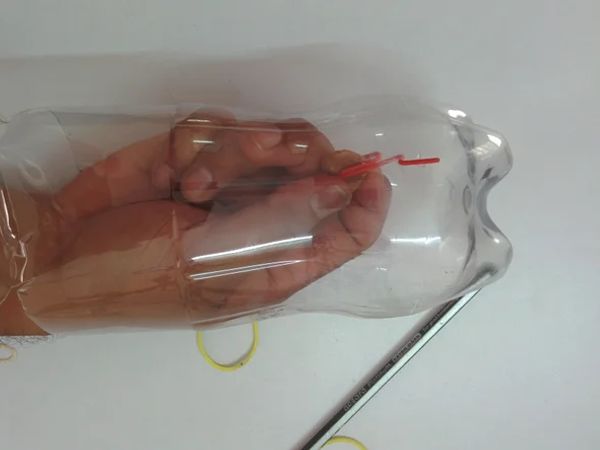 Insert paper clip into bottle