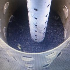 Barrel halfway filled with soil and gravel