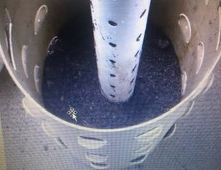 Barrel halfway filled with soil and gravel