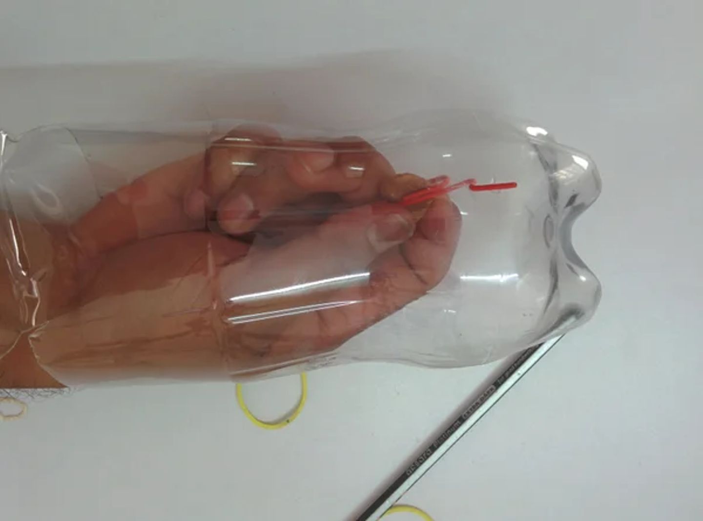 Insert paper clip into bottle