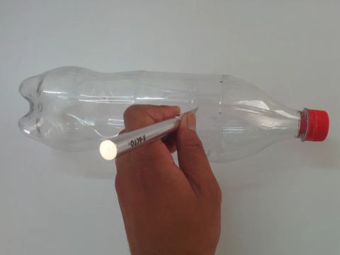 Cut the bottle in the upper part