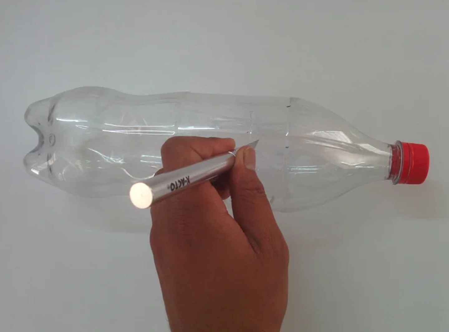 Cut the bottle in the upper part