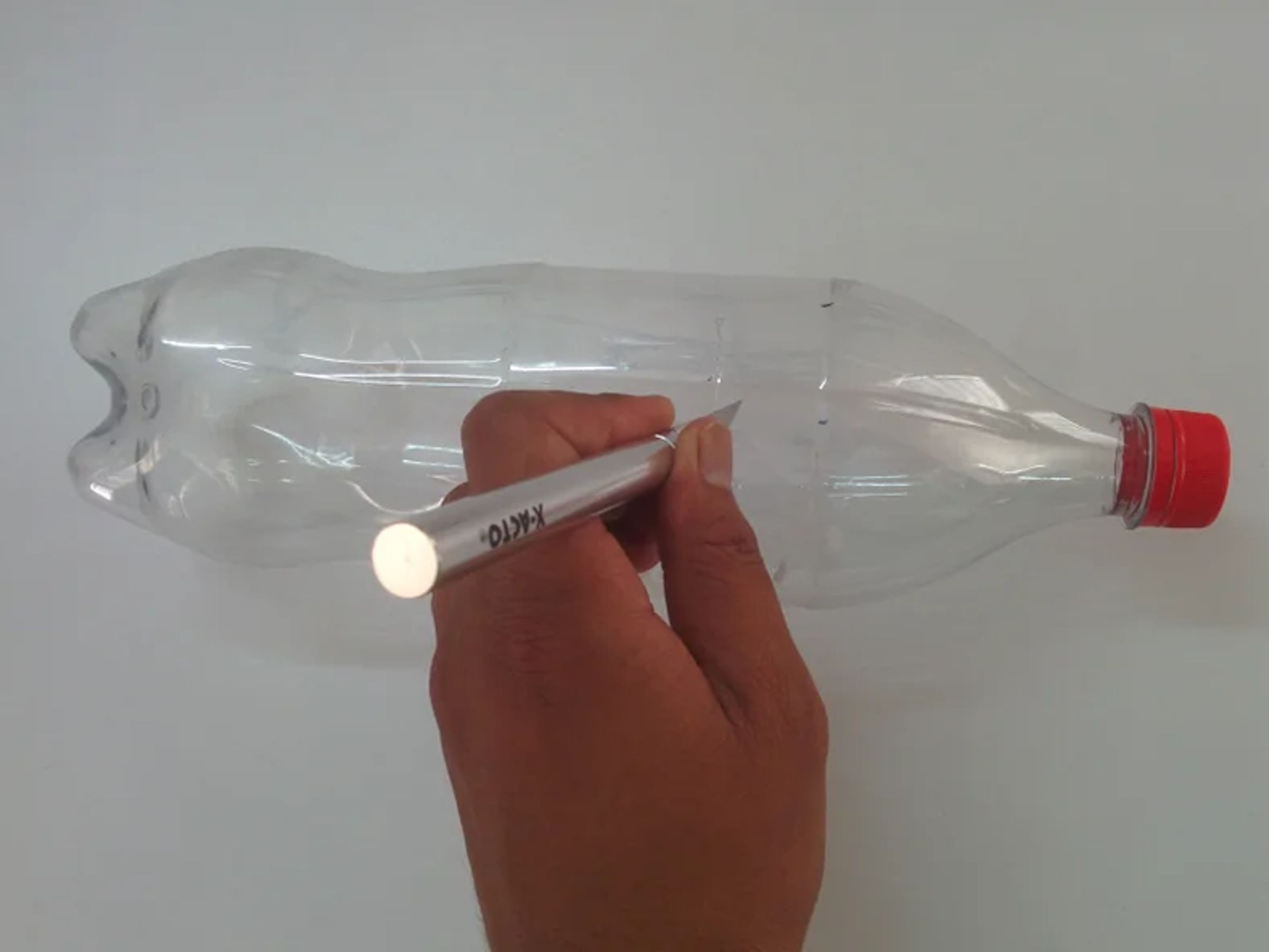 Cut the bottle in the upper part