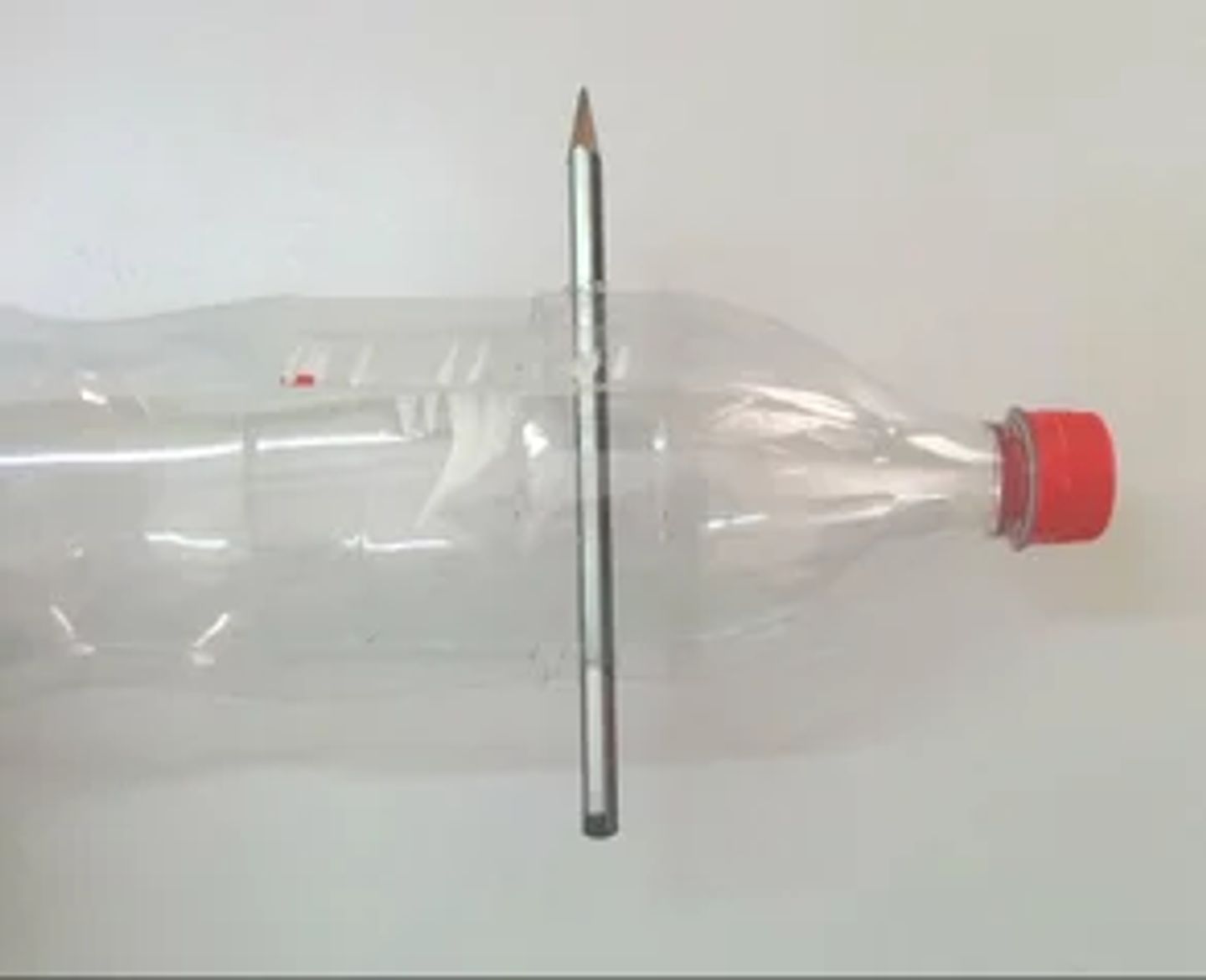 One of the pencils through the holes