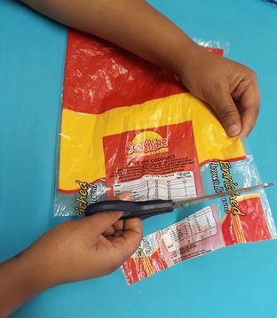 Cutting a 3cm strip straight across the bag making rings