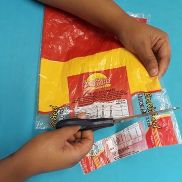 Cutting a 3cm strip straight across the bag making rings