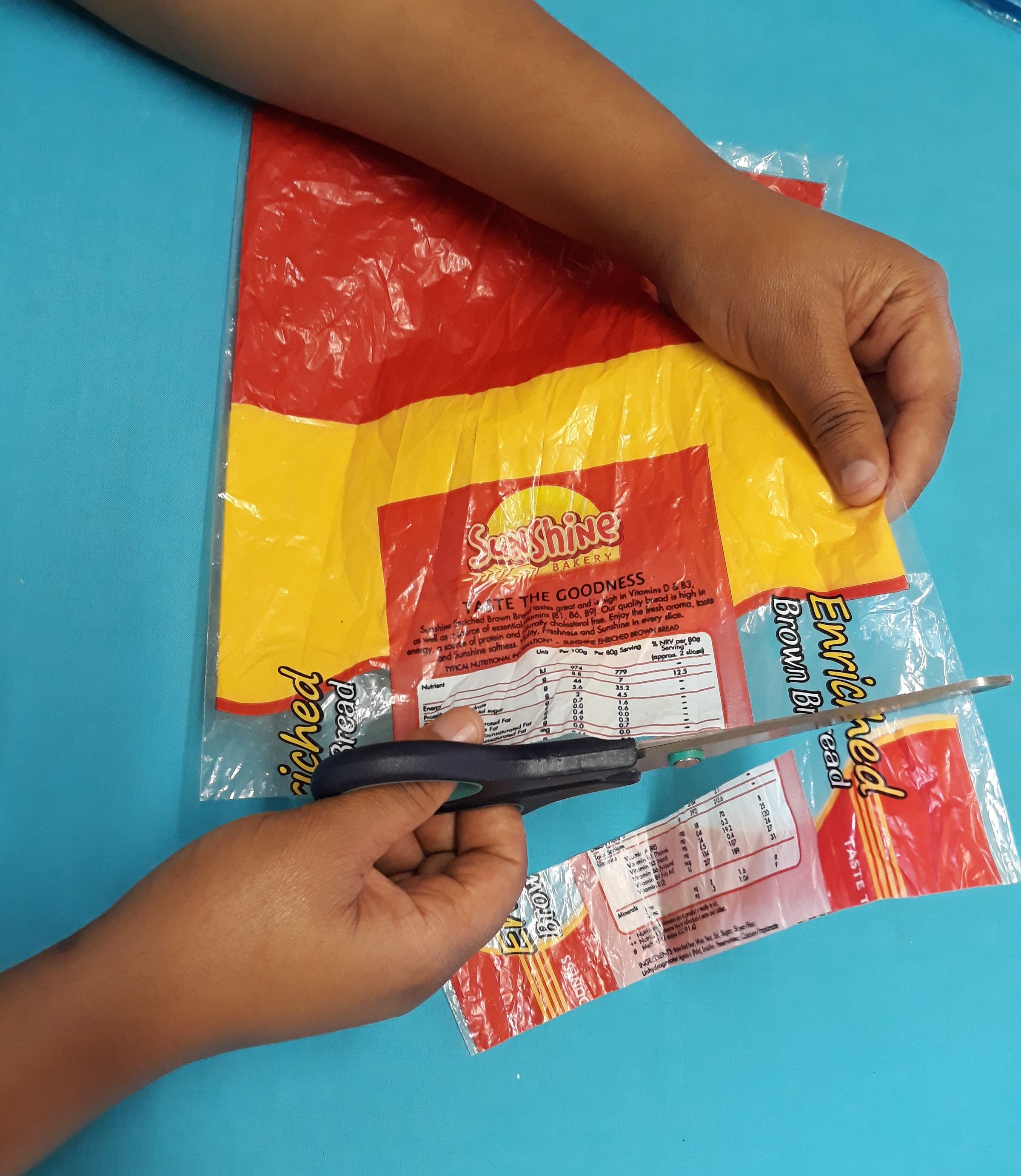 Cutting a 3cm strip straight across the bag making rings