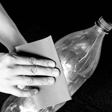 Scratching the surface of the PET bottle with sandpaper